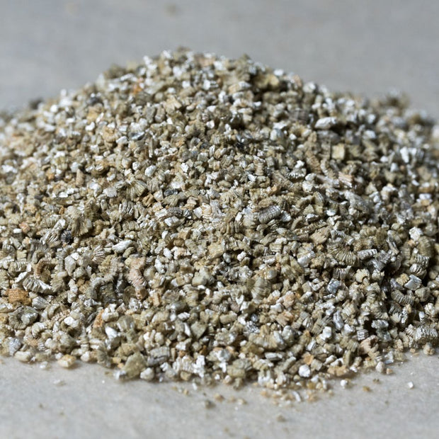 Pile of Alliance Chemical Organic Vermiculite - Fine Grade, showing the texture and color of the product.